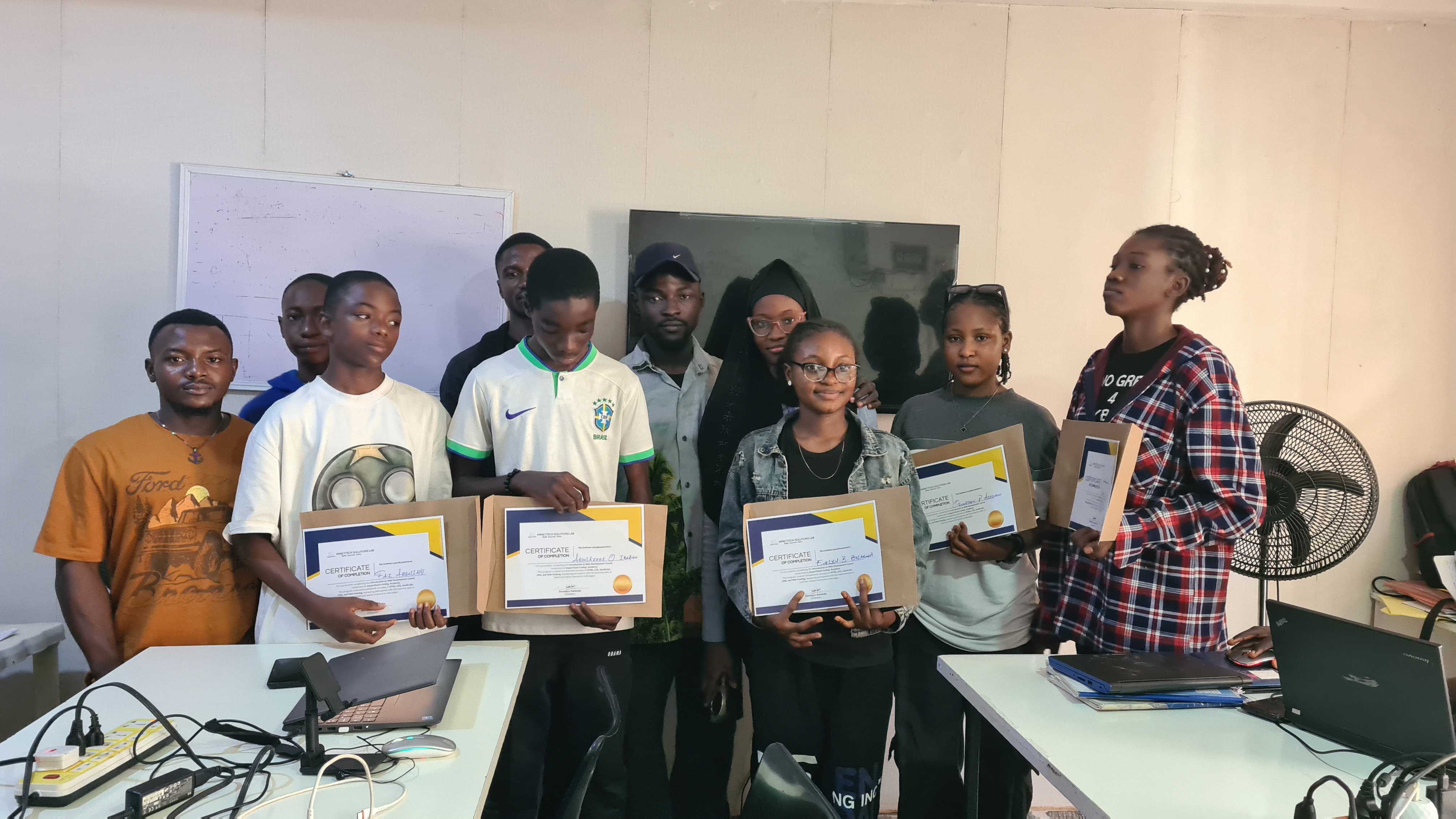 Students receiving mentorship in a technology training program